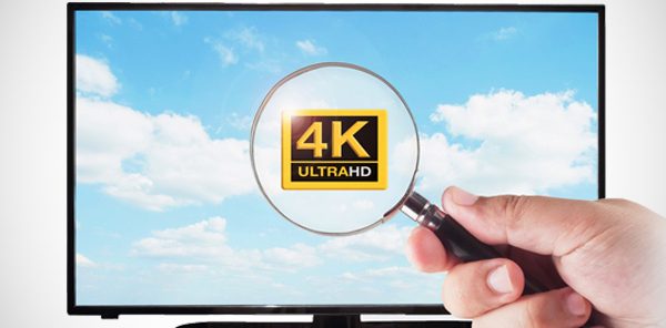 tv with a 4k ultraHD on the screen with a magnify glass over top of it reading